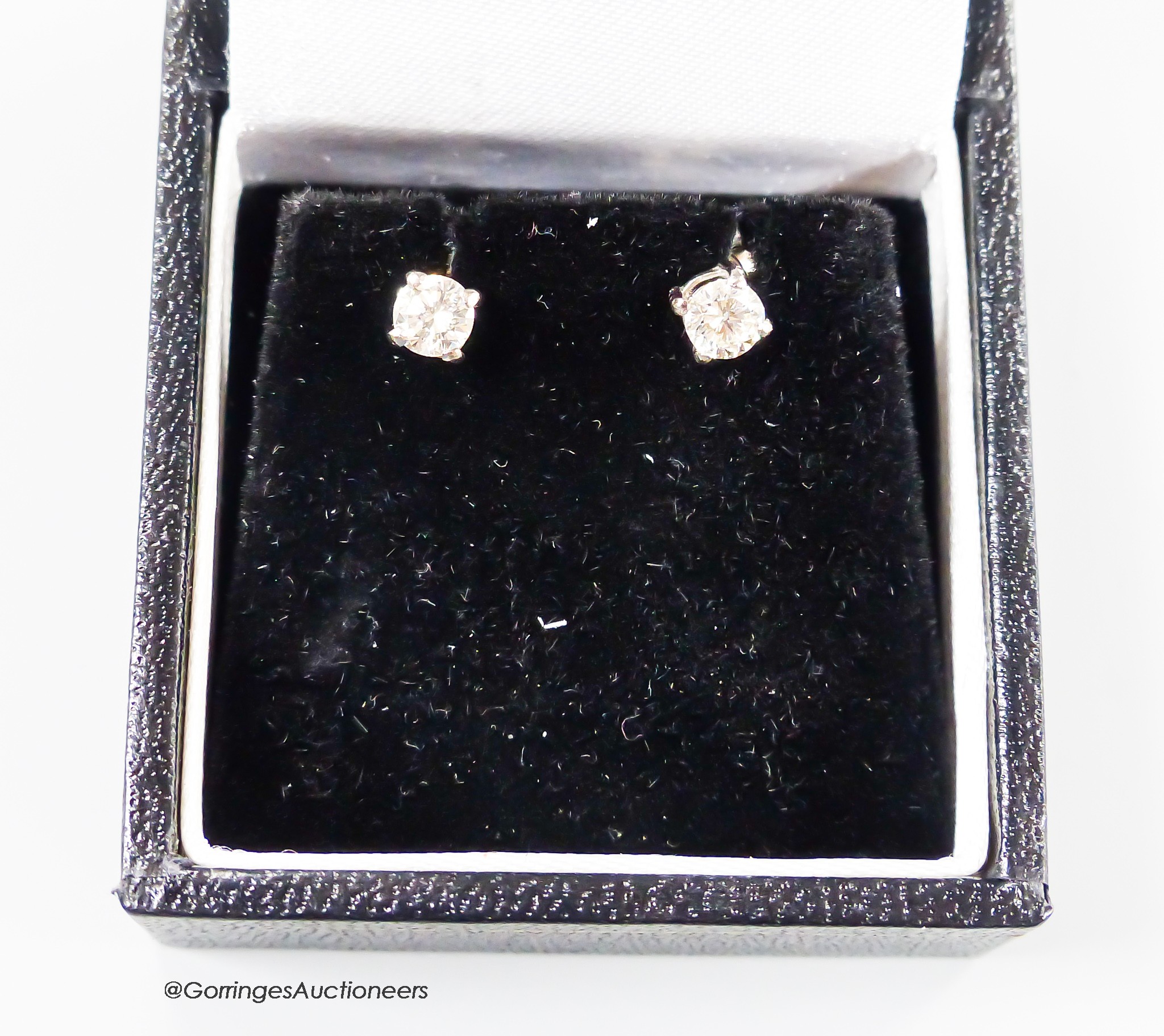 A modern pair of 750 white metal and solitaire diamond ear studs, each stone weighing approximately 0.23ct, gross weight 1.3 grams.